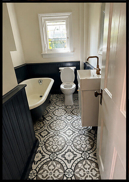 Finished bathroom with refinished clawfoot tub and patterned tile floor, Victorian duplex Belleville
