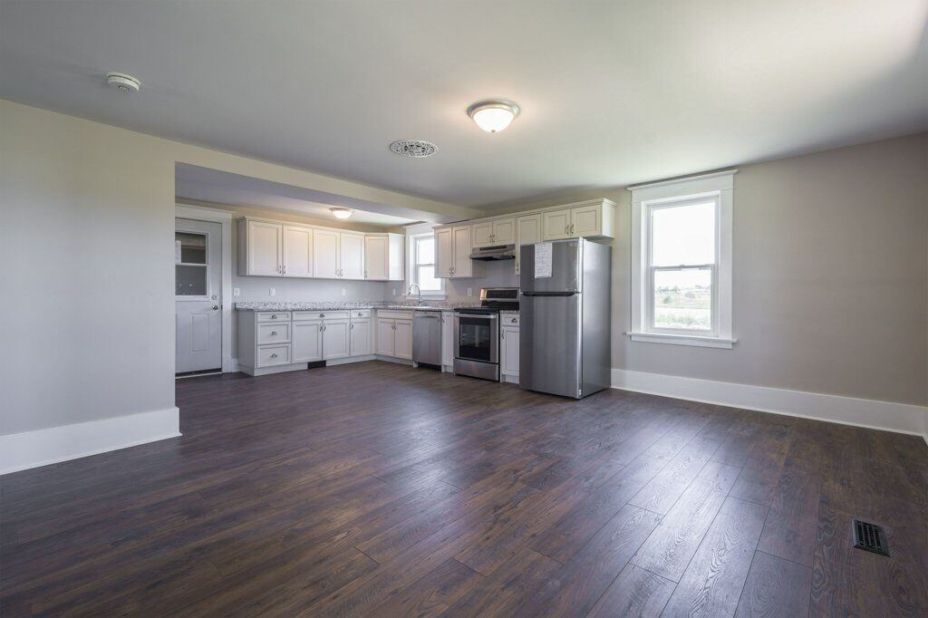After: wall removed, open-concept kitchen and eating area