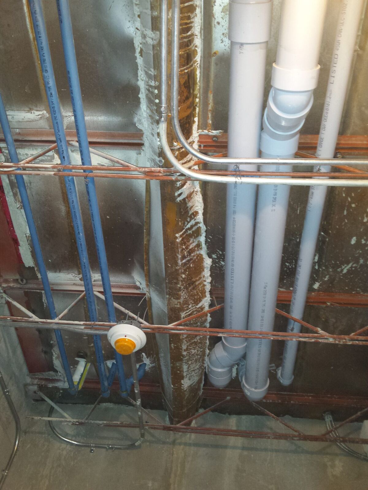 Before: exposed unpainted structural ceiling, ductwork and plumbing in the former bank