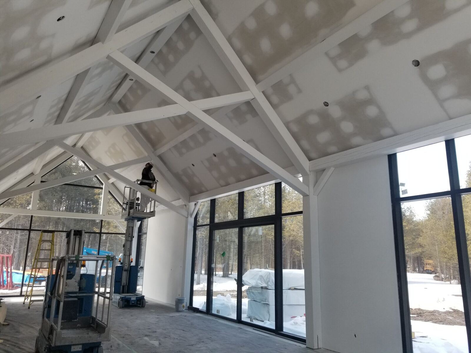 Before: unfinished timber-frame great room, exposed drywall and beams