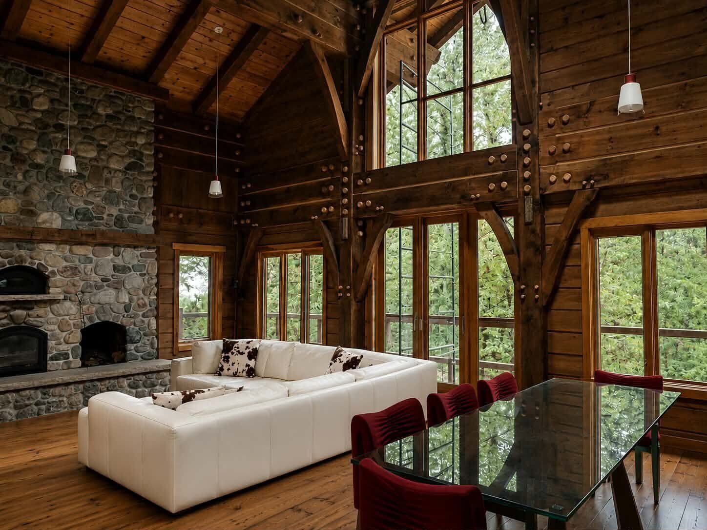 Timber-frame lodge interior with stone fireplace and custom wood finishing
